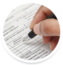 Close up of Person�s Hand Holding a Pen Filling out Tax Forms