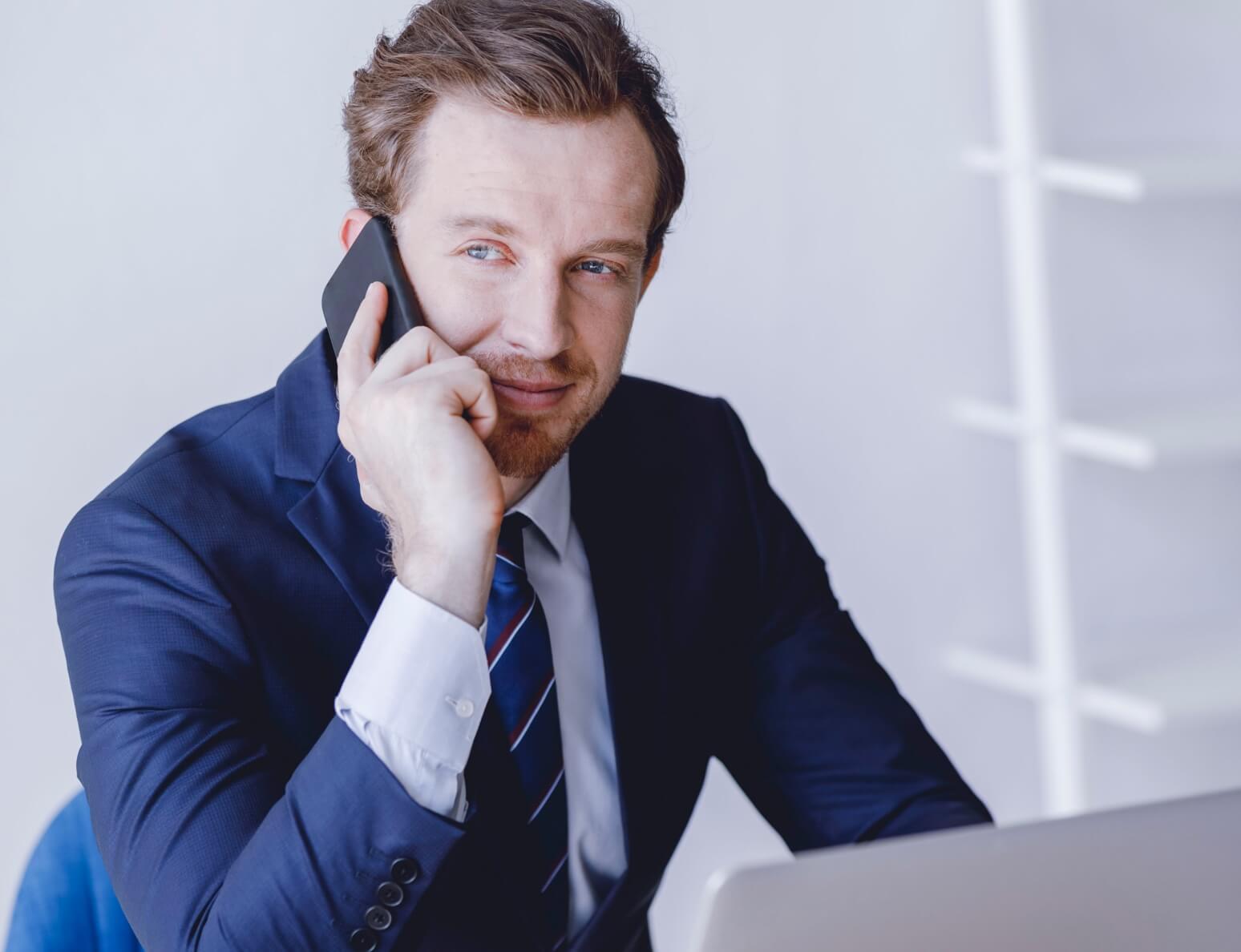 Man in suit speaking on mobile phone